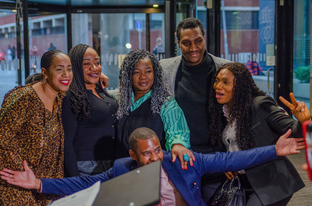 Participants sharing a positive moment around a screen